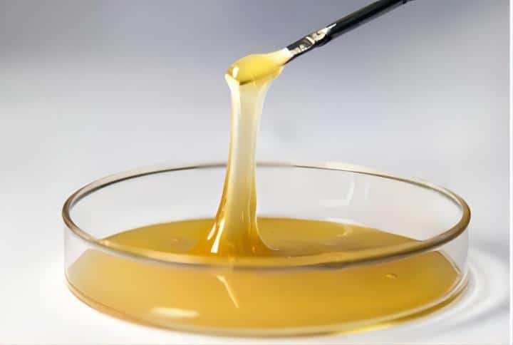 Yellow sticky liquid like glue or honey on a white background